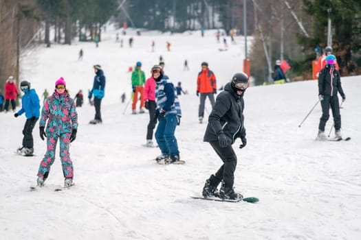 Szklarska Poreba, Poland - February 2019 : People skiing and snowboarding on the slopes of Szrenica mountain in Karkonosze mountains