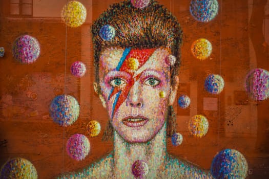 London, England - December 2018 : Graffiti in memory of singer David Bowie as Ziggy Stardust, Brixton