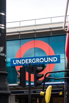 London, England - December 2018 : London Underground tube sign above the entrance to the Brixton station