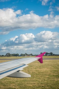 Luton, England - September 2018 : Window view of a wing of an aircraft during landing on the airport