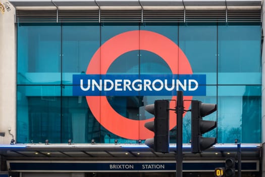 London, England - December 2018 : London Underground tube sign above the entrance to the Brixton station