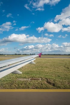 Luton, England - September 2018 : Window view of a wing of an aircraft during landing on the airport