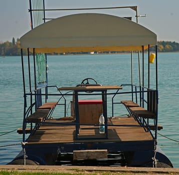 Floating raft docked at lake bank pier