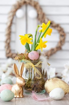 Freah daffodils and colorful eggs for a happy easter