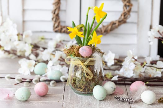 Freah daffodils and colorful eggs for a happy easter
