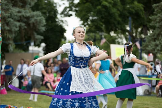 Frankenmuth, Michigan, USA - June 10, 2018 Members from the Frankenmuth dance center perform the maypole dance during the Bavarian Festival.