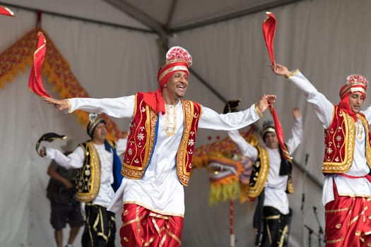 Columbus, Ohio, USA - May 27, 2018  A group of Bhangra dancers perform at the Asian Festival and the public join them in the dancing.