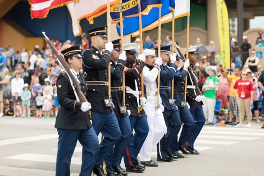 Indianapolis, Indiana, USA - May 26, 2018, Members of the USA Military carry the American flag at Indy 500 Parade