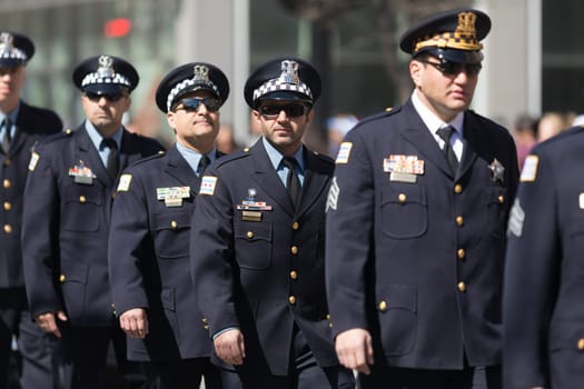 Chicago, Illinois, USA - April 29, 2018  Police officers marching down the street during the Greek Independence  Day Parade