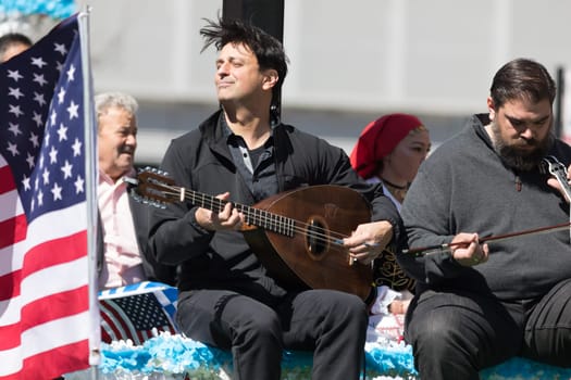 Chicago, Illinois, USA - April 29, 2018  Greek man playing the lavouto during the Greek Independence  Day Parade