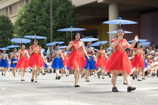 Indianapolis, Indiana, USA - May 26, 2018, Women wearing traditional chinese clothing and holding umbrellas from the Confucius Institute Indianapolis, from the IUPUI University  at the Indy 500 Parade