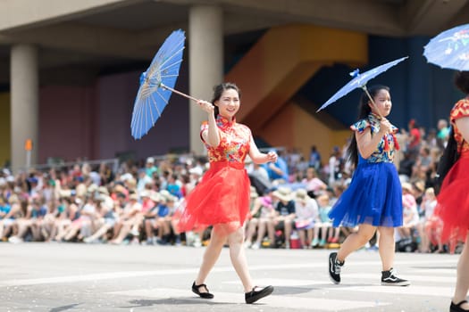 Indianapolis, Indiana, USA - May 26, 2018, Women wearing traditional chinese clothing and holding umbrellas from the Confucius Institute Indianapolis, from the IUPUI University  at the Indy 500 Parade