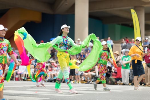 Indianapolis, Indiana, USA - May 26, 2018, Members of the Indianapolis Chinese Community Center, Inc.  Dancing while holding ribbons with their hands wearing traditional clothing at the Indy 500 Parade