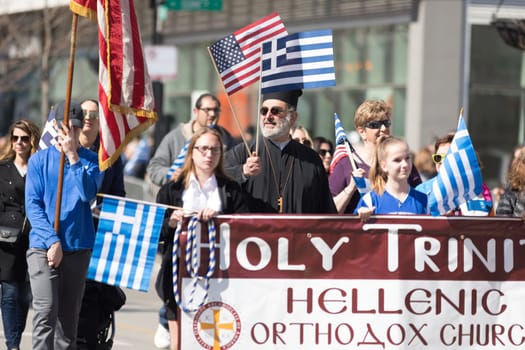 Chicago, Illinois, USA - April 29, 2018  Member of the holy Trinity Hellenic Orthodox Church at the Greek Independence  Day Parade