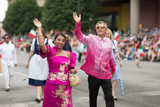 Indianapolis, Indiana, USA - May 26, 2018,  People from different countries with traditional clothing and carrying national flags at the Indy 500 Parade