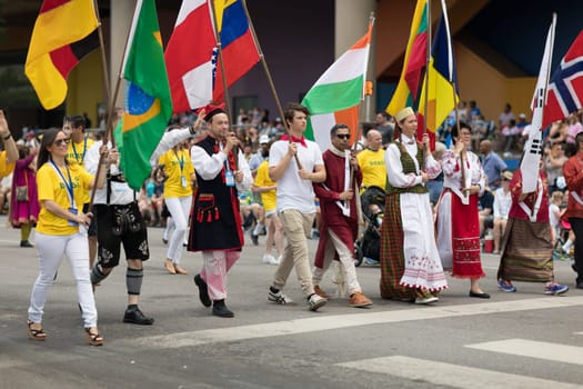 Indianapolis, Indiana, USA - May 26, 2018,  People from different countries with traditional clothing and carrying national flags at the Indy 500 Parade