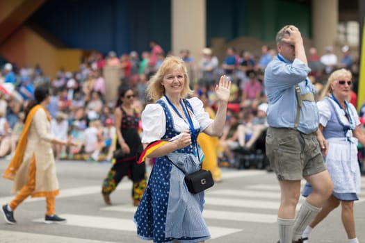 Indianapolis, Indiana, USA - May 26, 2018,  People from different countries with traditional clothing and carrying national flags at the Indy 500 Parade