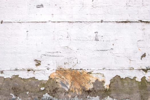 Background of rough wall painted white, ruined by the weather. Ideal for concepts and backgrounds.