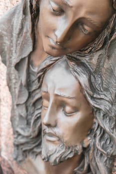 Bas-relief in bronze representing The Pity of Michelangelo. Faces of Holy Mary mother and Jesus Christ after the Crucifixion.