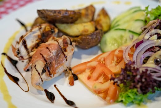 Grilled bacon and ham wrapped chicken breast,  served with summer salad and roast potatoes
