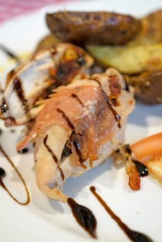 Grilled bacon and ham wrapped chicken breast,  served with summer salad and roast potatoes