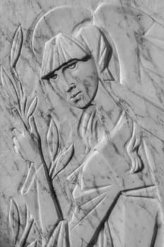Bas-relief of a woman holding an olive tree. It can be used as backgrounds and concepts.