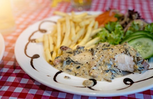 Grilled chicken breast with honey glazed mustard sauce meal served with summer salad and chips