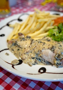 Grilled chicken breast with honey glazed mustard sauce meal served with summer salad and chips