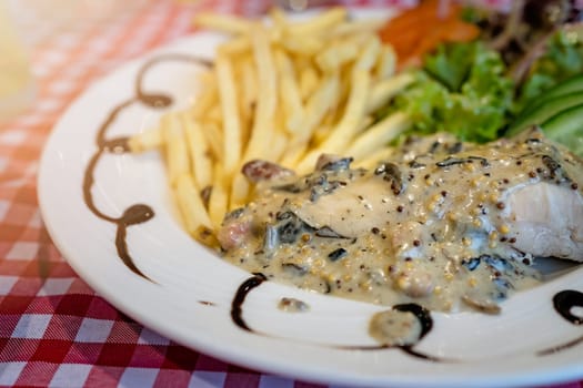 Grilled chicken breast with honey glazed mustard sauce meal served with summer salad and chips