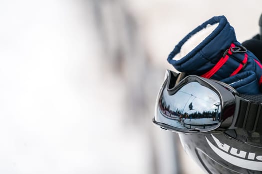 Ski helmet, gloves, googles and ski poles left in the snow on the mountain slope in winter