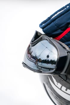 Ski helmet, gloves, googles and ski poles left in the snow on the mountain slope in winter