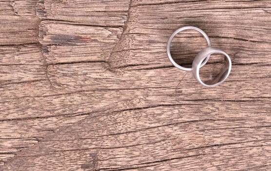 Wedding rings isolated on old wood, selective focus