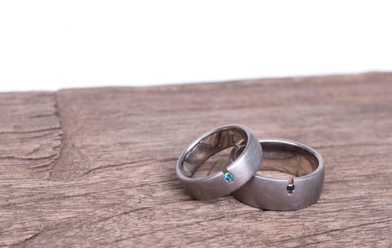 Wedding rings isolated on old wood, selective focus