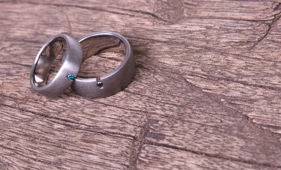 Wedding rings isolated on old wood, selective focus