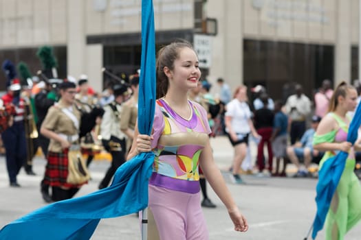 Indianapolis, Indiana, USA - May 26, 2018, Members from different high school from the state of indiana form a large marching band and cheerleaders, and march down the road at the Indy 500 Parade