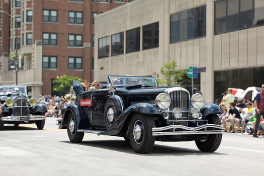 Indianapolis, Indiana, USA - May 26, 2018,  A group of collectible classic cars go down the road at the Indy 500 Parade
