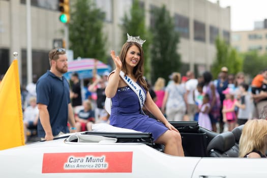Indianapolis, Indiana, USA - May 26, 2018, Cara Mund, Miss America 2018 riding on an Oldsmobile 1970 classic car, at the Indy 500 Parade