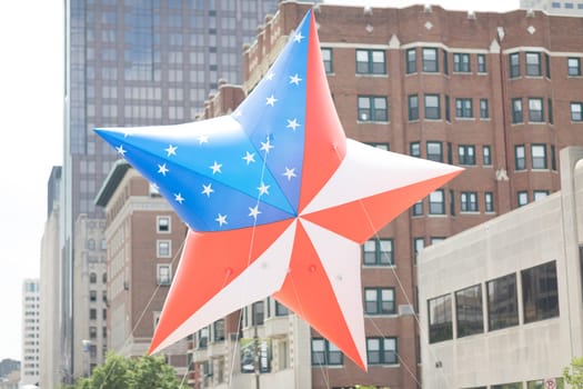 Indianapolis, Indiana, USA - May 26, 2018, Members of the Gold Star Families of Indiana carry a giant balloon in shape of a star with the colors of the American Flag at the Indy 500 Parade