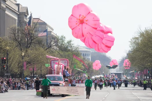 Washington, D.C., USA - April 14, 2018 Floats and  Flower shaped balloons in the 2018 National Cherry Blossom Parade