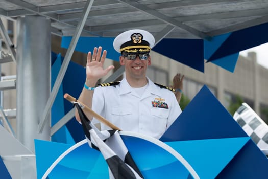 Indianapolis, Indiana, USA - May 26, 2018, A float of the 500 festival carries members of the US Navy, down the road, at the Indy 500 Parade