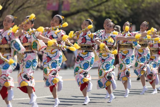 Washington, D.C., USA - April 14, 2018 Japanese women wearing kimonos and dancing in the 2018 National Cherry Blossom Parade