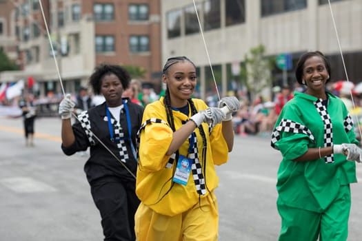 Indianapolis, Indiana, USA - May 26, 2018, People holding down a giant balloon in shape of a race driver, going down the street at the Indy 500 Parade