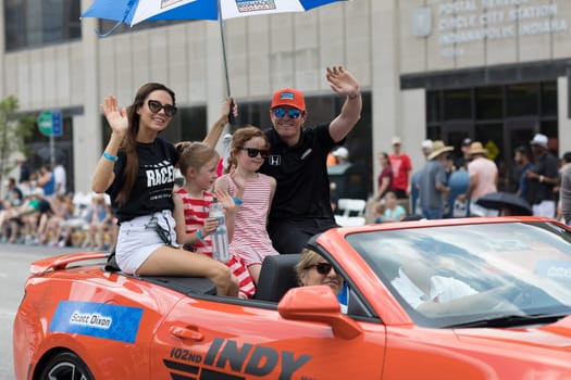 Indianapolis, Indiana, USA - May 26, 2018, Indycar driver Scott Dixon and his family on a car going down the road at the Indy 500 Parade