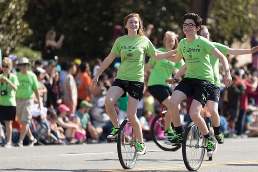 Washington, D.C., USA - April 14, 2018 Children riding unicycles in the 2018 National Cherry Blossom Parade