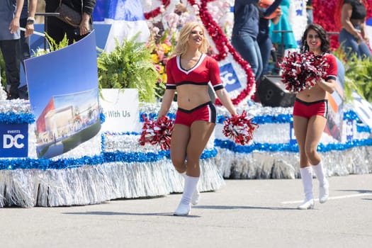 Washington, D.C., USA - April 14, 2018 Cheerleader dancing while walking down the street in the 2018 National Cherry Blossom Parade