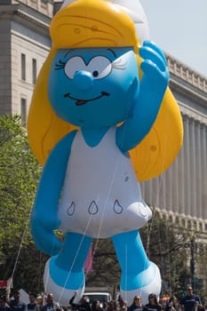 Washington, D.C., USA - April 14, 2018 A balloon in shape of Smurfette going down the road in the 2018 National Cherry Blossom Parade