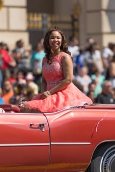 Washington, D.C., USA - April 14, 2018 Lady on a classic car going down the road  in the 2018 National Cherry Blossom Parade