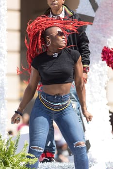 Washington, D.C., USA - April 14, 2018 African American woman on a float dancing while going down the road in the 2018 National Cherry Blossom Parade