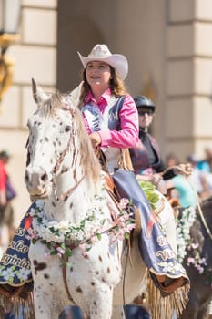 Washington, D.C., USA - April 14, 2018 A woman riding a horse covered in cherry flowers in the 2018 National Cherry Blossom Parade