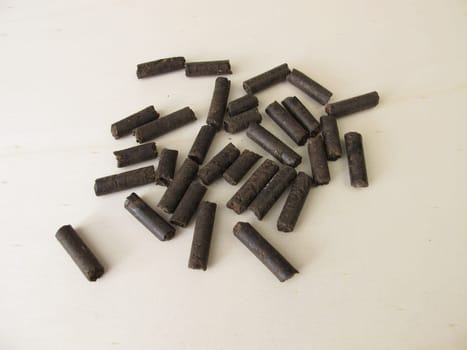 Horse manure pellets for fertilizing on wooden board